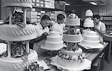 Decorators putting final touches on wedding cakes. Let us create the perfect cake for your special day!