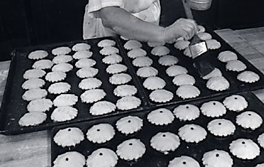 Brushing on glaze before baking to add extra beauty to our already glorious pastries.